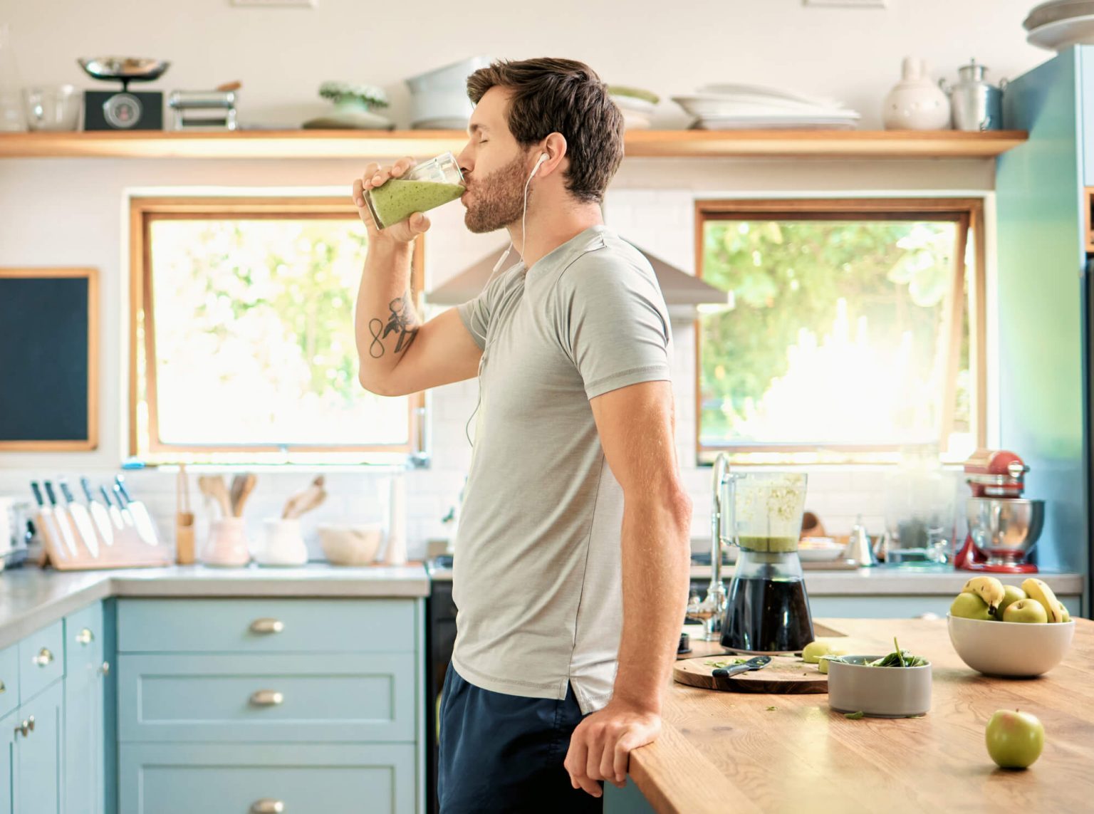 Athletic man drinking a smoothie, fueling for an upcoming workout