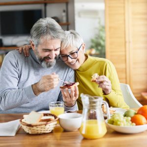 Couple eating a healthy breakfast together at home