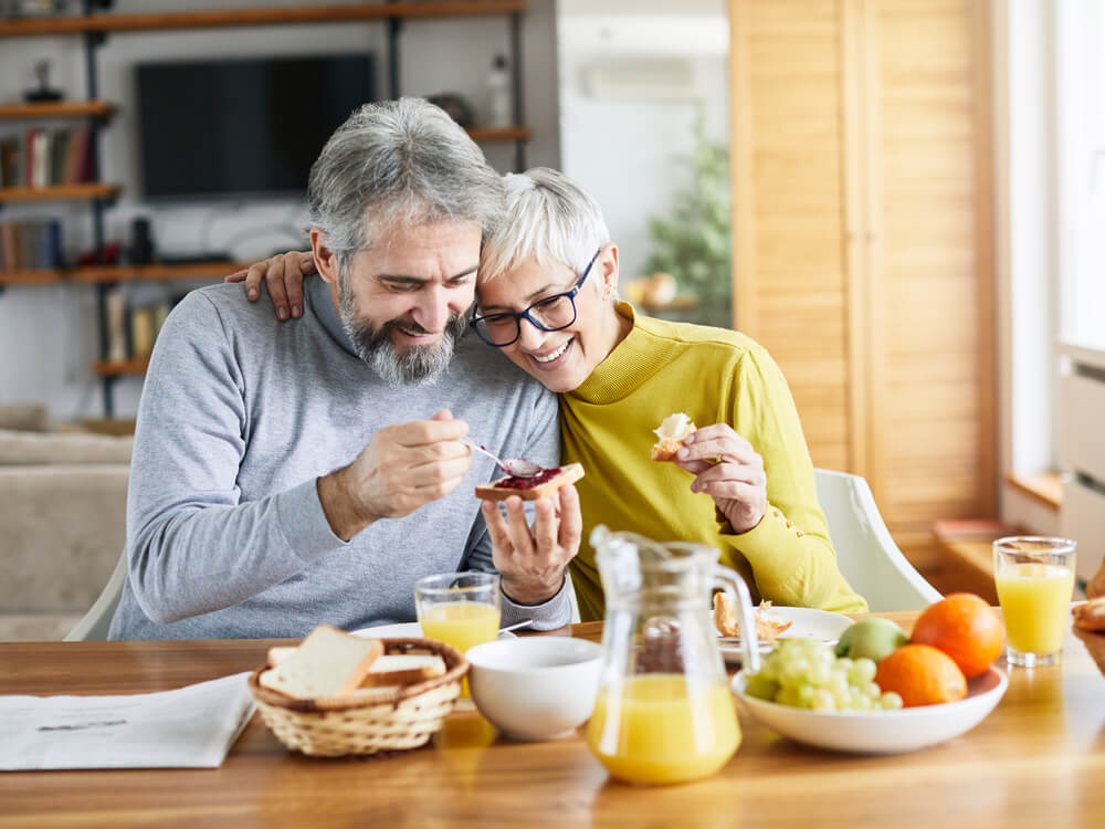 Couple eating a healthy breakfast together at home